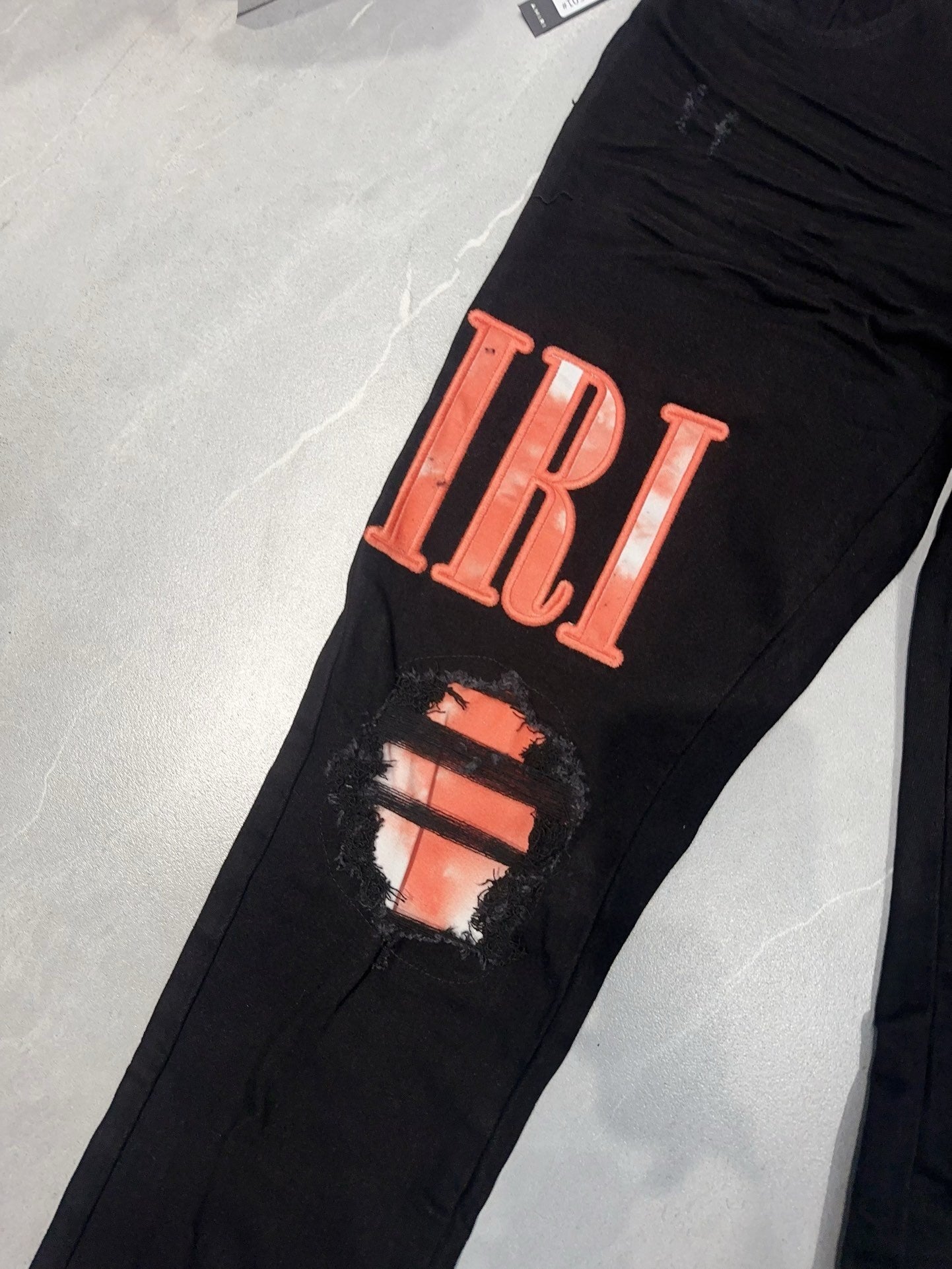 AMIRI WAXED LOGO-APPLIQUE SKINNY JEANS