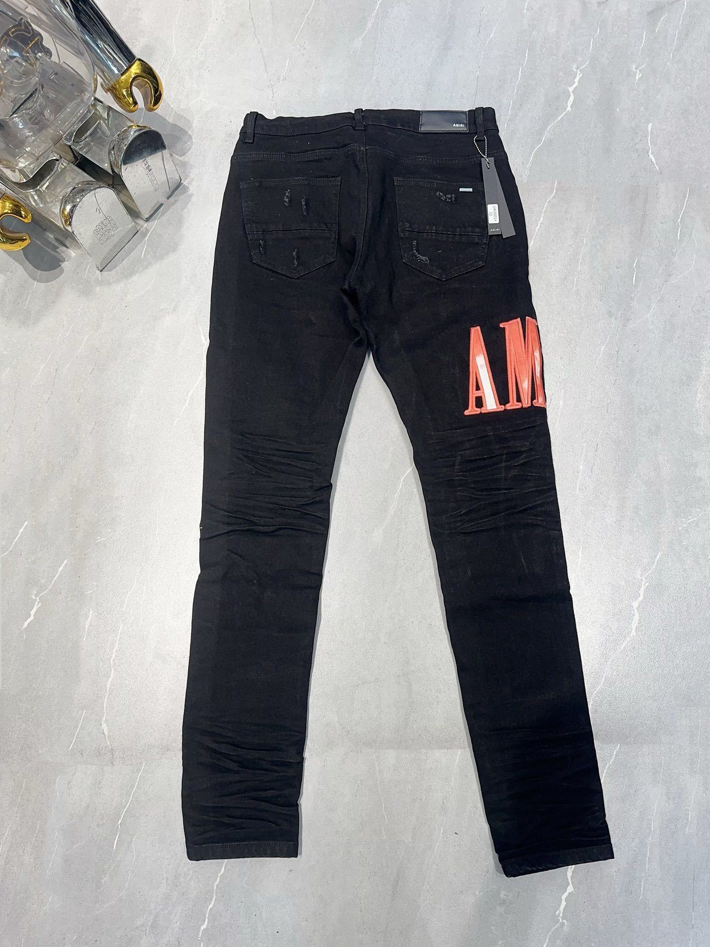 AMIRI WAXED LOGO-APPLIQUE SKINNY JEANS
